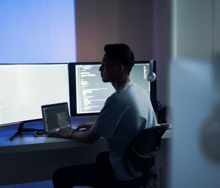 Web design, coding and Asian man with a computer for programming a website at night. Cyber security, developer and programmer reading information for a software database on a pc in a dark office