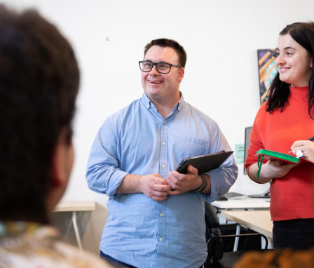 Man hosts meeting beside his rehabilitation counselor