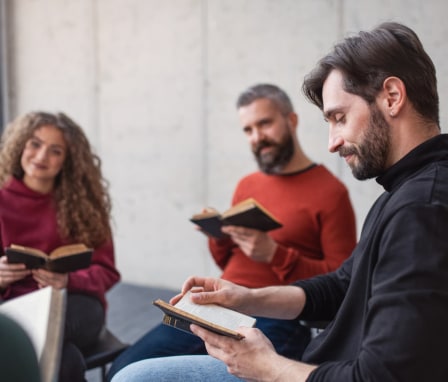 Pastoral counselor leading reading with group