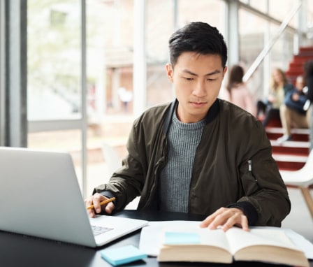 College student looking at textbook