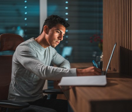 Forensic psychology doctoral student studying on laptop