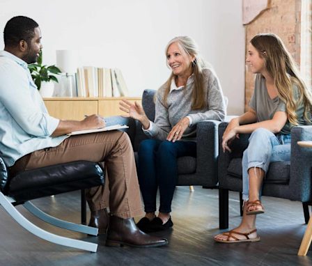 Family counselor talking to mom and daughter