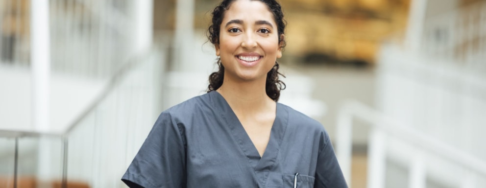 Portrait of smiling nurse standing in hospital
