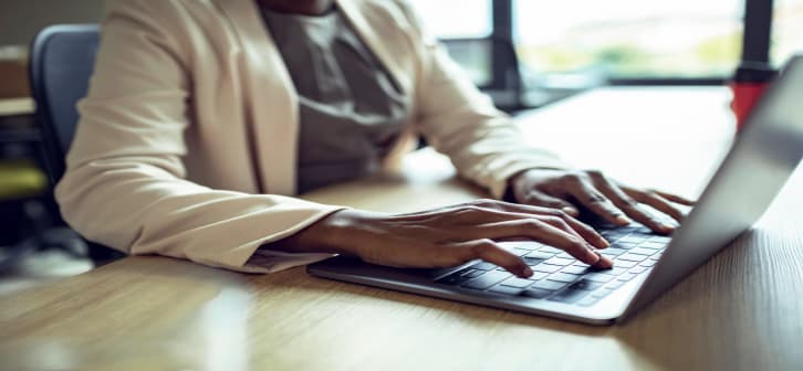 A close up of a bootcamp student working on her laptop.