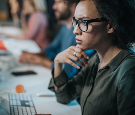 Woman looking at code on computer