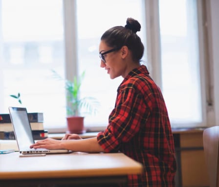 Young woman working on her laptop at home. Image Credit: mihailomilovanovic / E+ / Getty Images