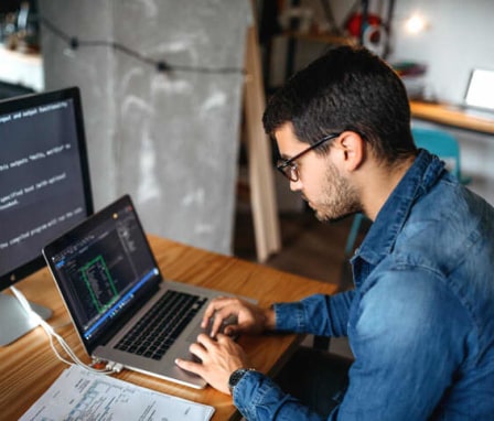 Male programmer coding at home. Image Credit: Creative DJ / E+ / Getty Images