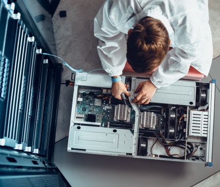 Person working on the hardware of a computer tower