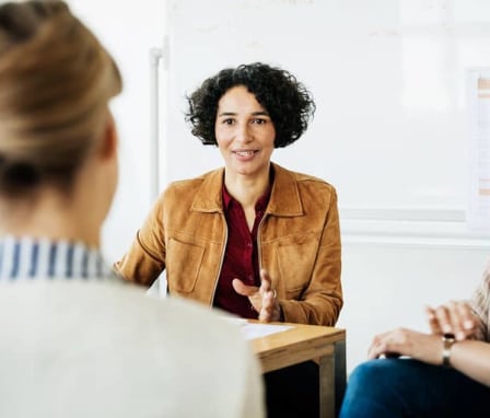 Three professional colleagues talking to each other