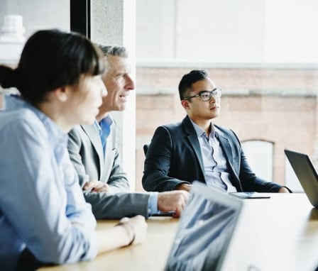 Three business colleagues in a meeting together