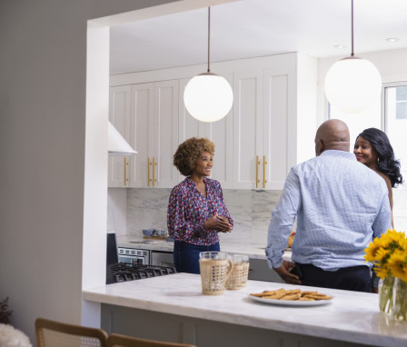 Real estate agent showing kitchen to couple