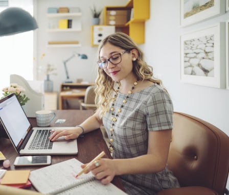 Woman working at desk on laptop