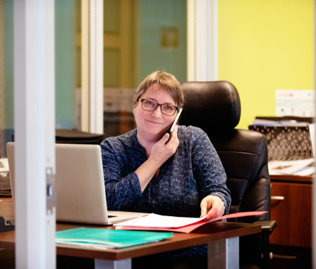 Woman on the phone working at a desk