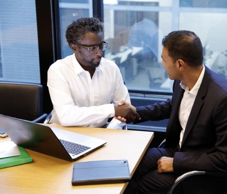 Two men shaking hands in a business meeting