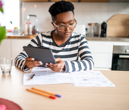 Person studying charts and holding a tablet