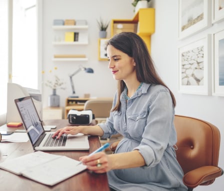 Woman working on laptop showing a graph