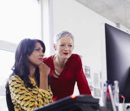 Two people working together on a computer