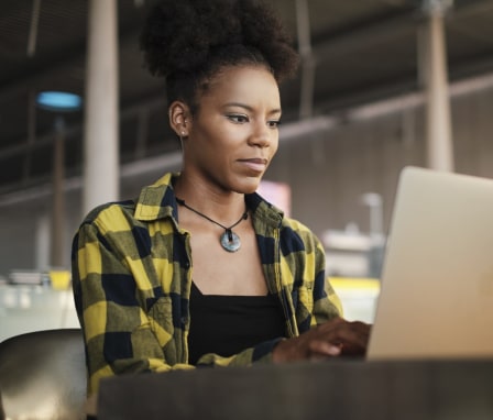 Woman on laptop in library