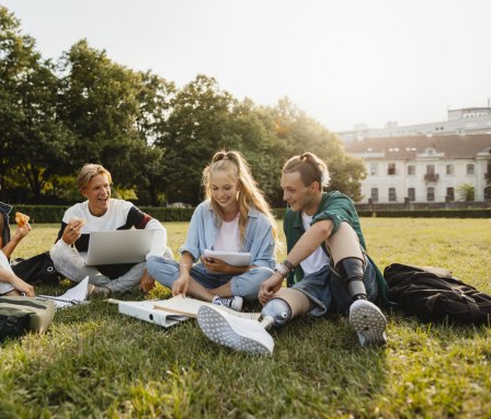 Students studying together in grass