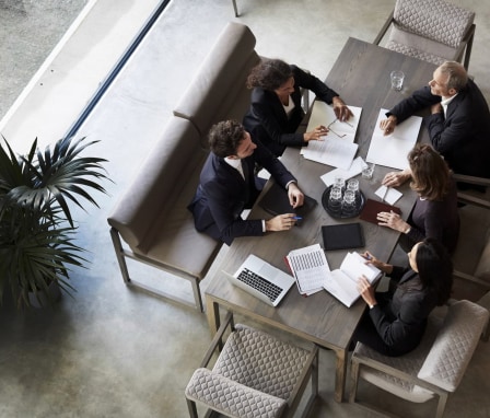 Five professionals working at a table