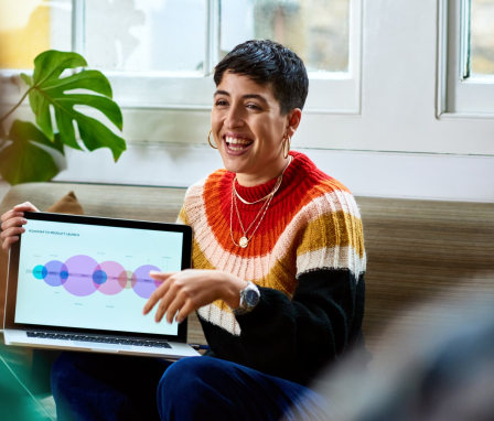 Business person showing laptop in meeting