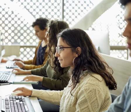 Students typing on computers in class