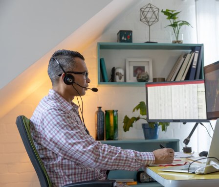 Man working on spreadsheets and graphs on a computer