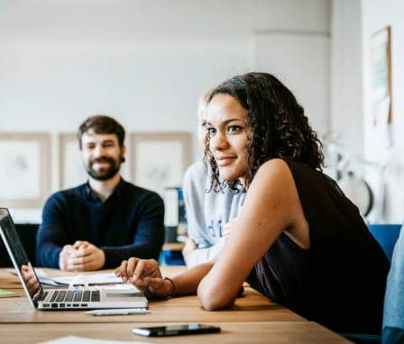 Young woman with a laptop in a business meeting