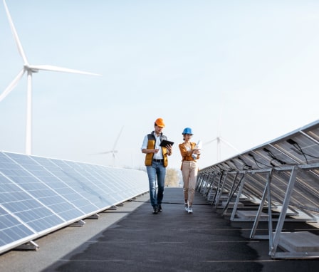 Two professionals walking through a solar power plant