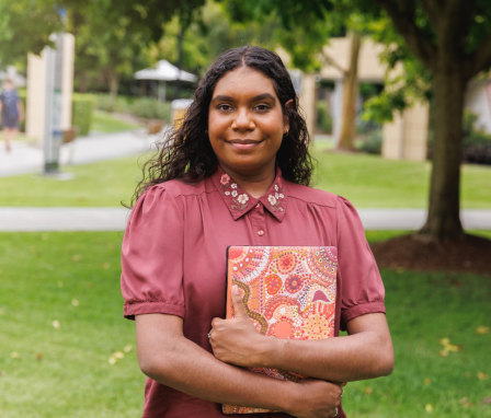 Woman student holding laptop