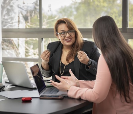 Professional Latina woman helping client