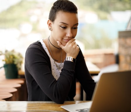 Young person outside on laptop computer