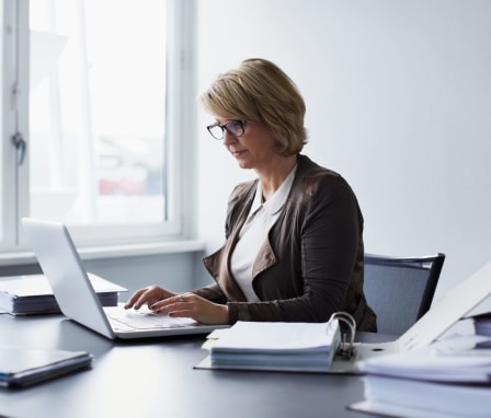 Woman working on laptop in a business office