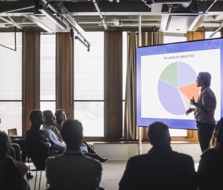 Person gives a presentation about Green Technology to a group