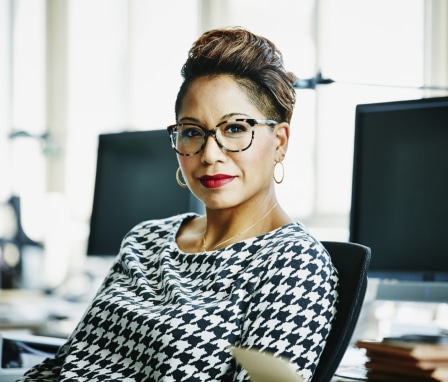 Professional woman seated at a computer