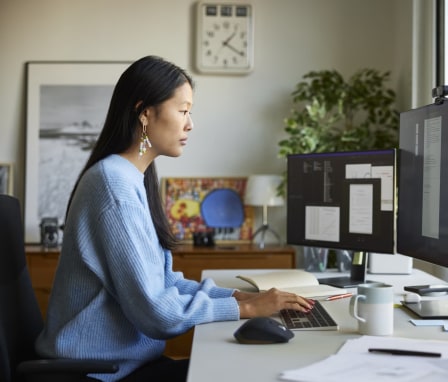 Woman working on desktop computer in home office