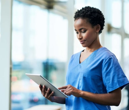 Nurse updating info on tablet