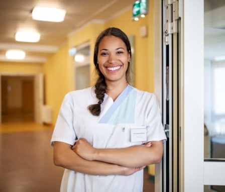Female nurse standing at doorway