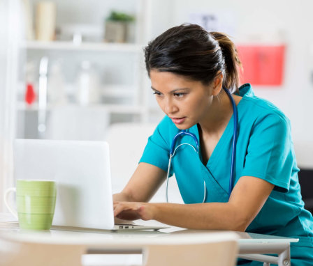 Female nursing student studying on laptop