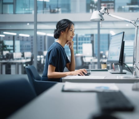 Woman using desktop computer in office