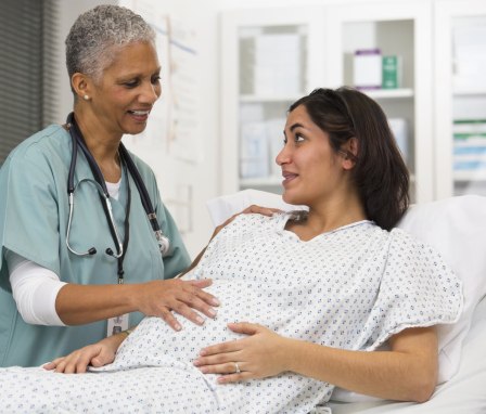 Nurse examining pregnant patient's belly