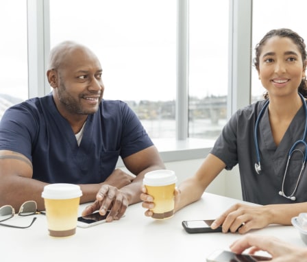 Nurses talking to each other at a cafe table