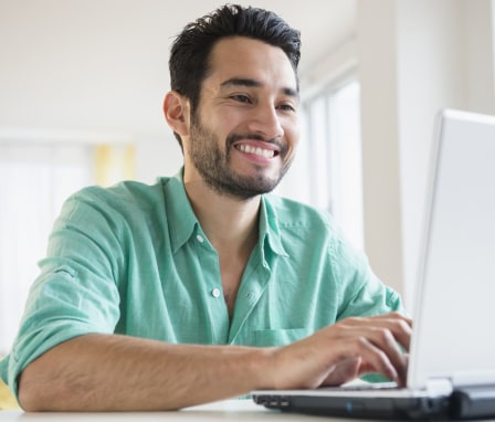 Man typing cover letter on a laptop