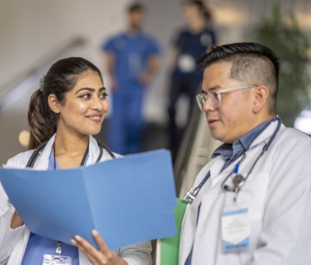 Nurses looking at a resume in a folder