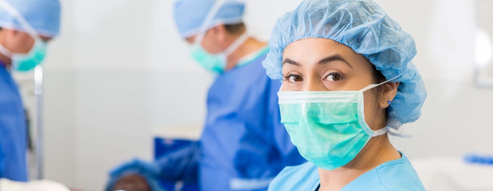 Nurse assisting prior to a surgery