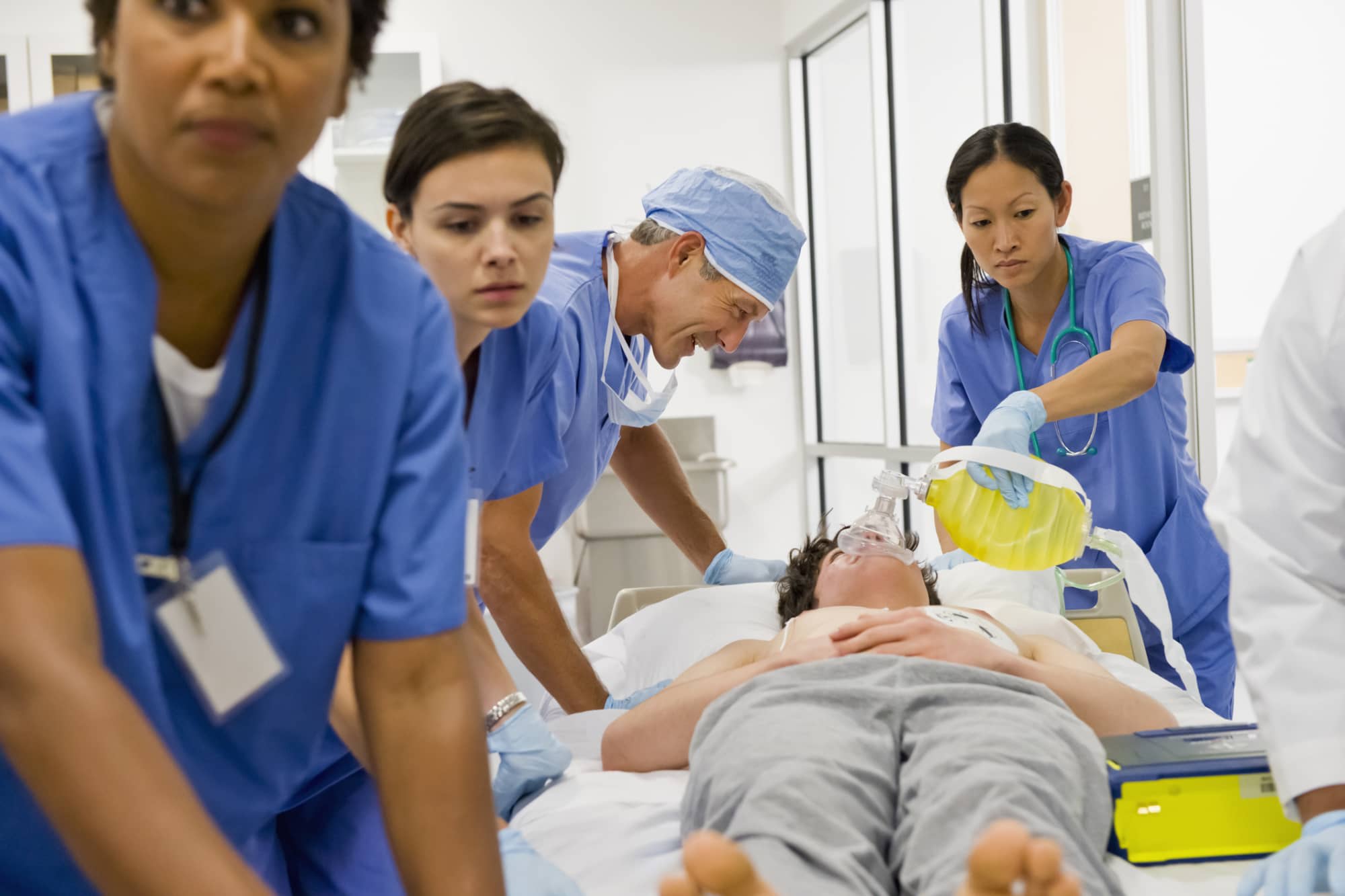 Nurses and doctor working together on a patient lying down