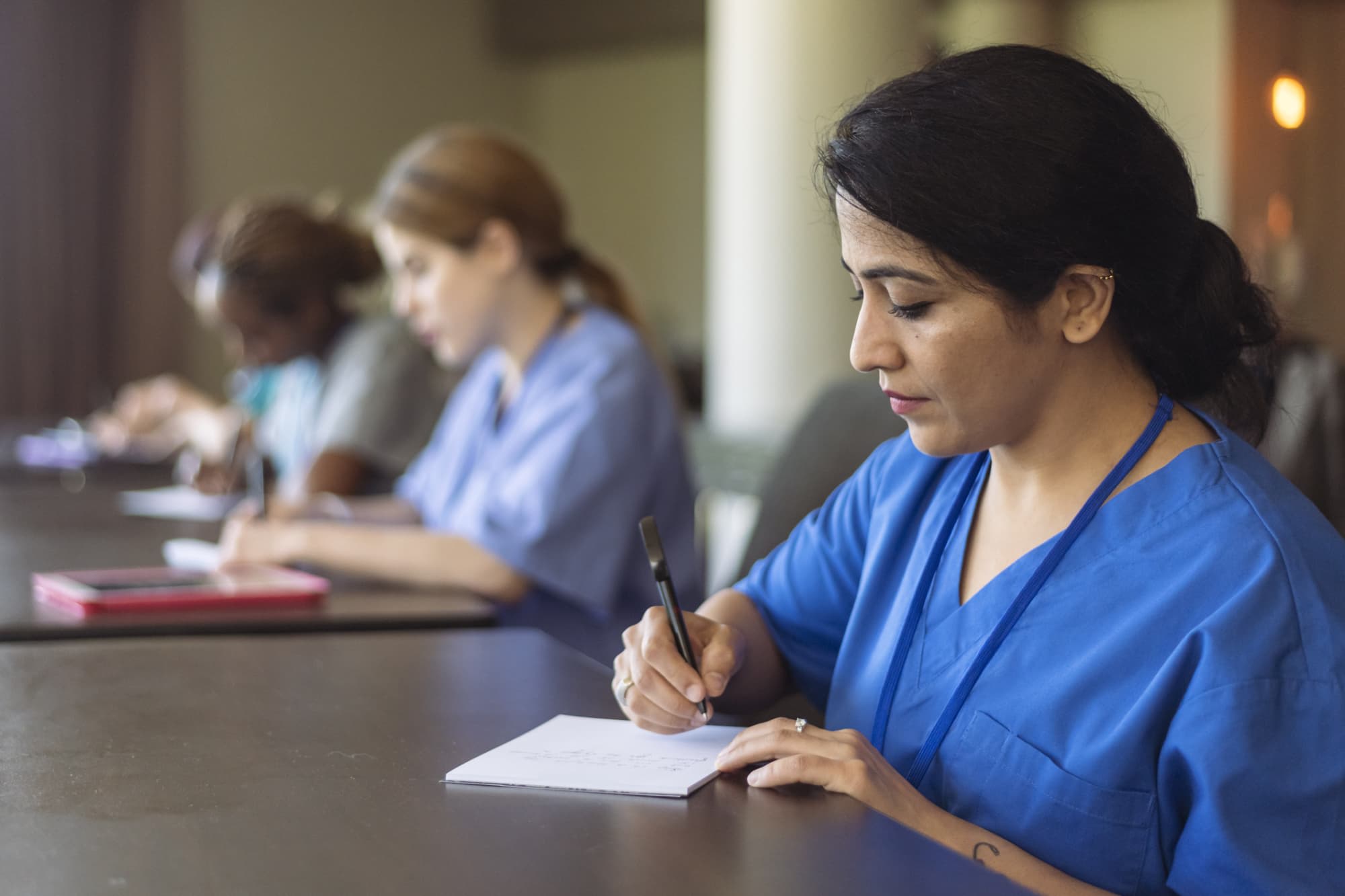 Nurses taking notes in classroom