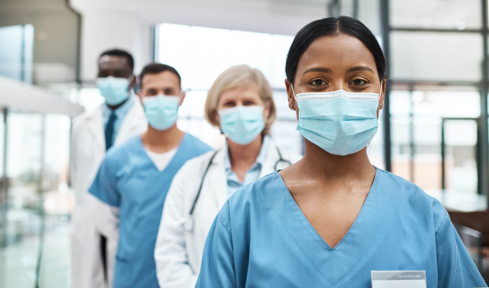 Medical practitioners wearing face masks while standing together in a hospital