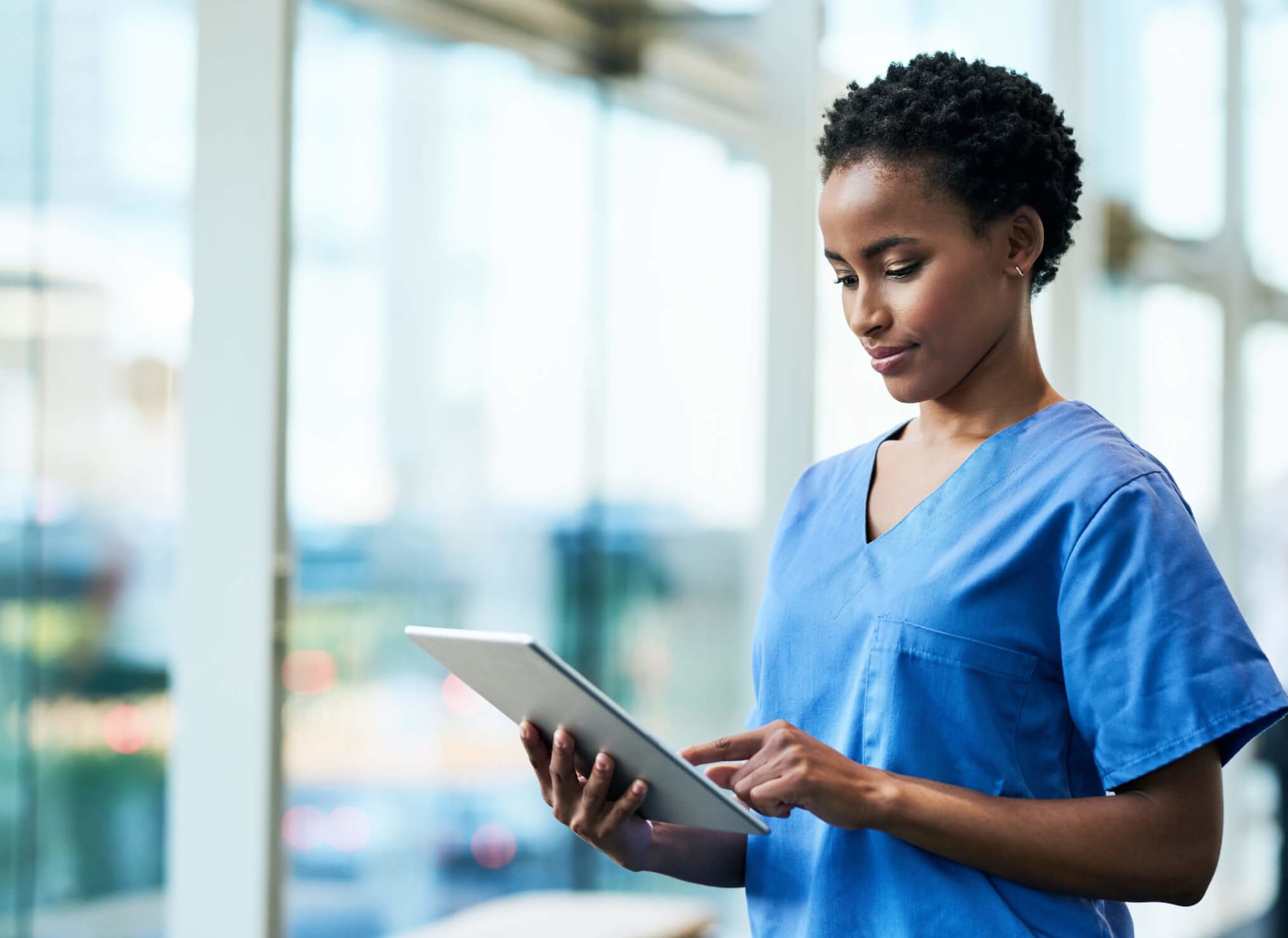 Nurse updating info on tablet