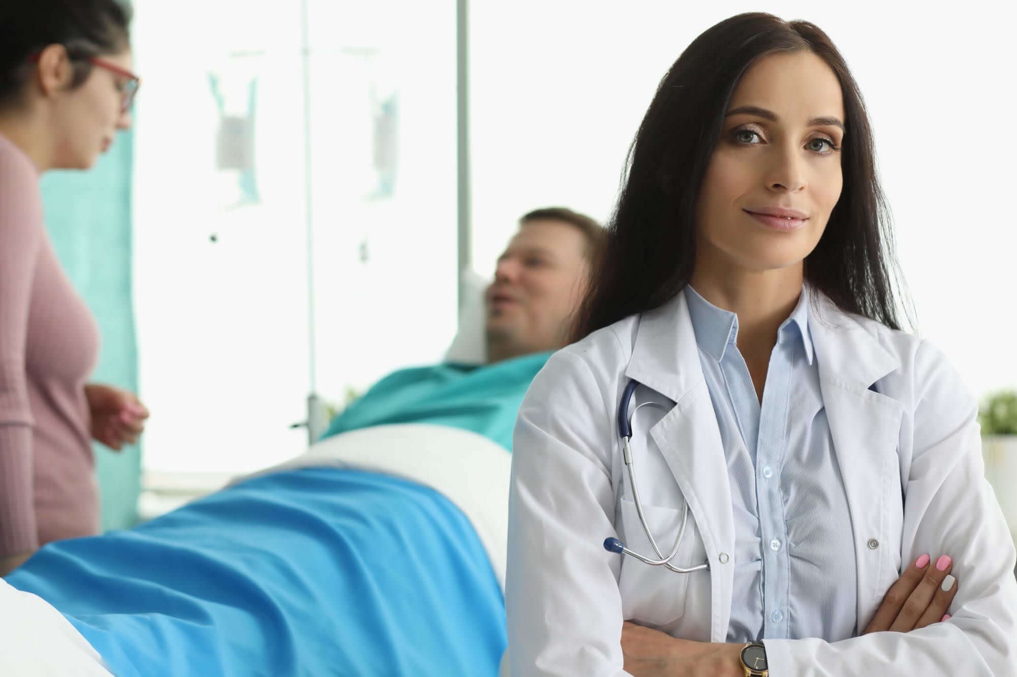 Nurse posing with patient in background